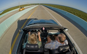 Image 2 - Amy Pierson, left, and Ken Mausolf ride in a convertible car along the southern portion of the completed 18-Mile Stretch, an almost seven-year, $330 million construction project that provides a safer drive to and from the Keys. 